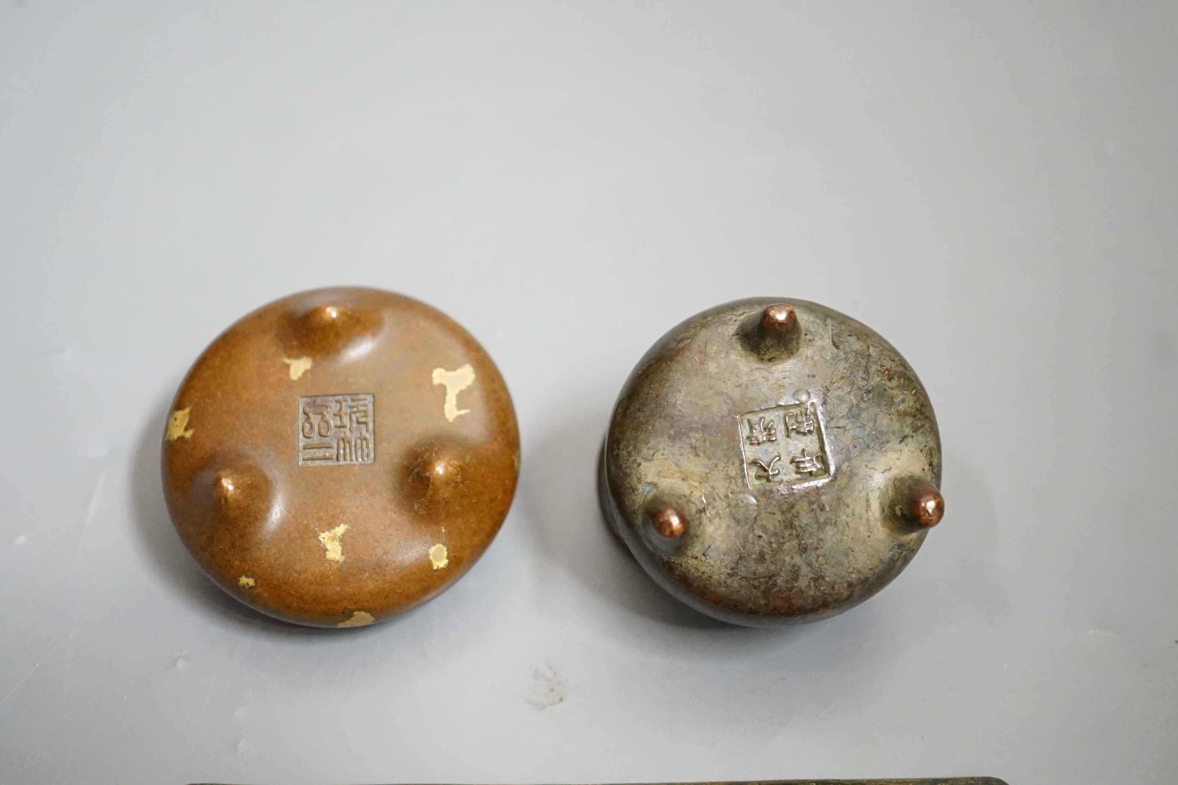 Two small bronze two handled censers and an Ordos style pierced bronze monkey panel, 13cms wide